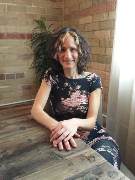 Angel Morgan giving a psychic reading, warm amber and sepia setting.